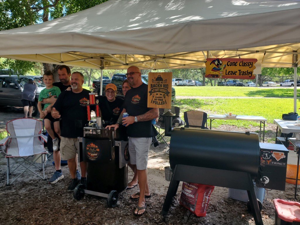 The team and their families gathered under the canopy beside the pits at a cookout